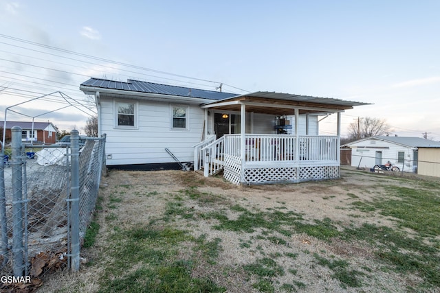 rear view of house with covered porch