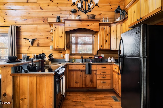 2017 Smoky Cove Rd, Sevierville, TN 37876 - kitchen with black appliances, a sink, wood finished floors, a chandelier, and dark countertops