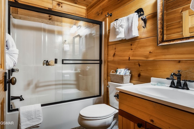 2017 Smoky Cove Rd, Sevierville, TN 37876 - full bath with bath / shower combo with glass door, toilet, vanity, and wooden walls