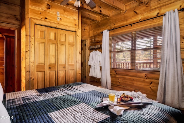 2017 Smoky Cove Rd, Sevierville, TN 37876 - bedroom featuring wood walls, beamed ceiling, wooden ceiling, and a closet