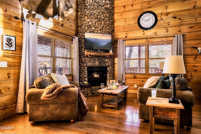 2017 Smoky Cove Rd, Sevierville, TN 37876 - living room with hardwood / wood-style flooring, wood walls, and a stone fireplace