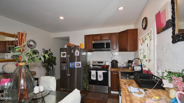 1625 Worth St, Knoxville, TN 37917 - kitchen with stainless steel appliances, backsplash, recessed lighting, a sink, and dark wood-type flooring
