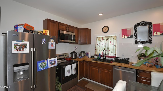 1625 Worth St, Knoxville, TN 37917 - kitchen with appliances with stainless steel finishes, a sink, decorative backsplash, dark wood finished floors, and recessed lighting