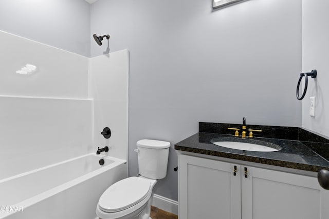 bathroom featuring toilet, vanity, and bathing tub / shower combination