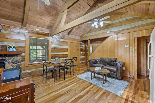 living room featuring wood walls, light hardwood / wood-style flooring, ceiling fan, and wood ceiling