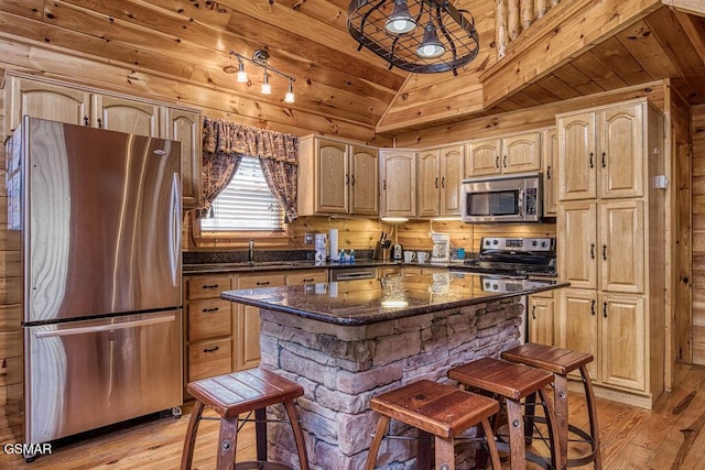 kitchen featuring light brown cabinets, light wood finished floors, lofted ceiling, appliances with stainless steel finishes, and wooden ceiling