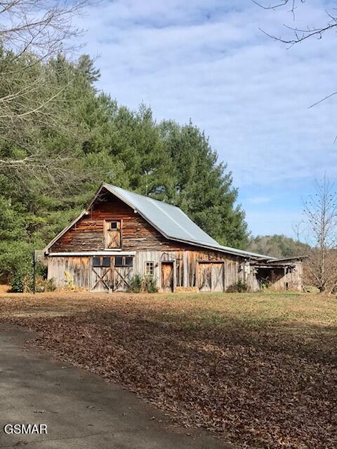 view of side of property with an outbuilding