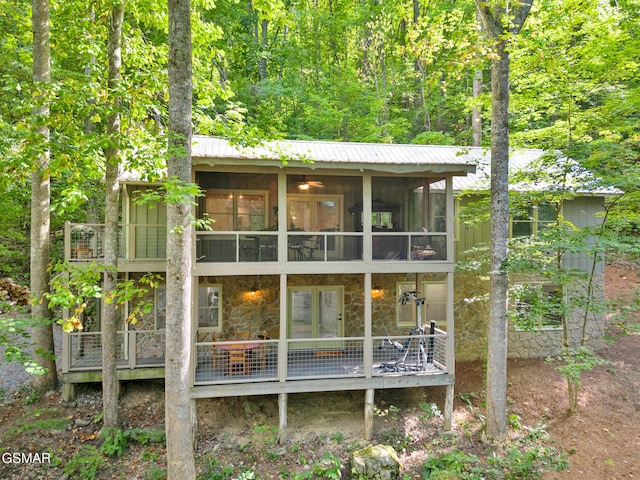 back of house featuring a sunroom