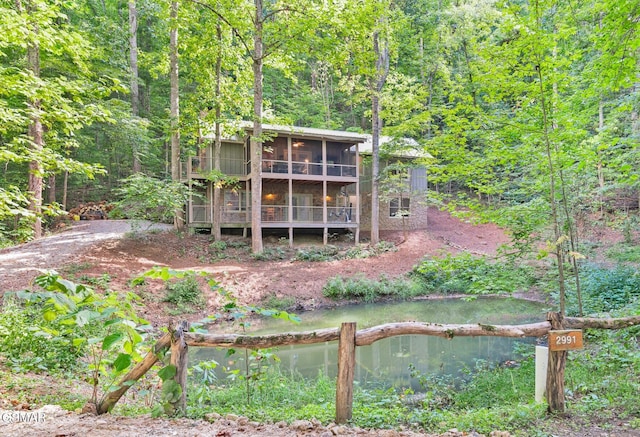 back of house featuring a water view and a sunroom