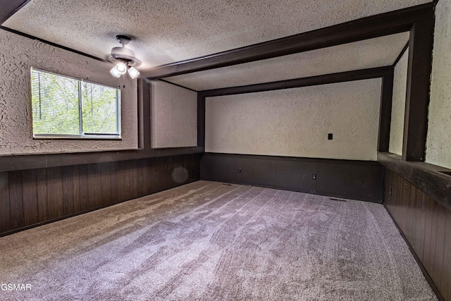 1721 Birch Dr # A1, Sevierville, TN 37876 - home theater room featuring wooden walls, a textured ceiling, a textured wall, and carpet