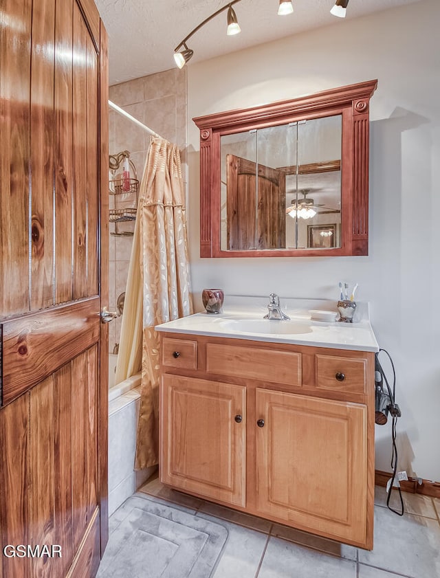 150 Florence Cir, Dandridge, TN 37725 - bathroom featuring a textured ceiling, vanity, ceiling fan, shower / bathtub combination with curtain, and tile patterned flooring
