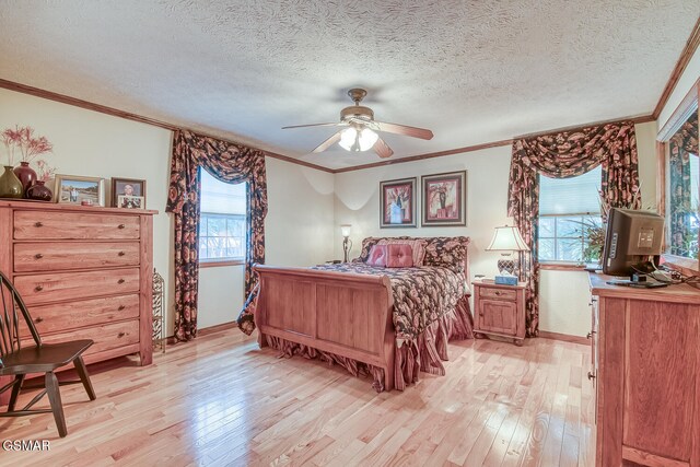 150 Florence Cir, Dandridge, TN 37725 - bedroom with ceiling fan, crown molding, light wood-type flooring, and a textured ceiling