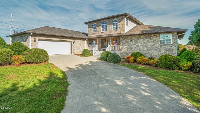 150 Florence Cir, Dandridge, TN 37725 - view of front of house featuring a garage, covered porch, and a front lawn