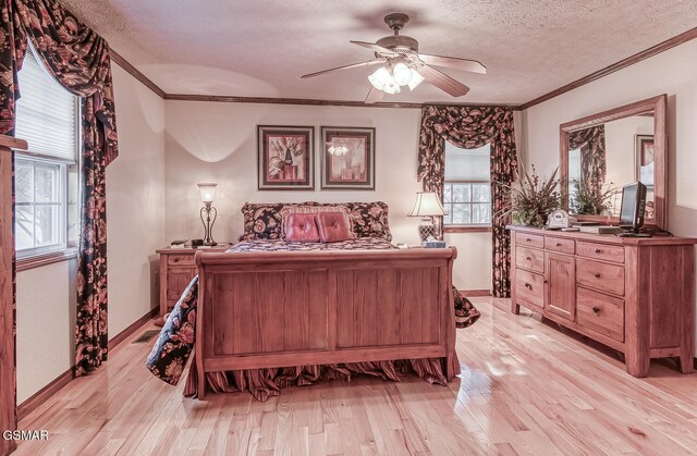 150 Florence Cir, Dandridge, TN 37725 - bedroom featuring a textured ceiling, light hardwood / wood-style flooring, ceiling fan, and ornamental molding