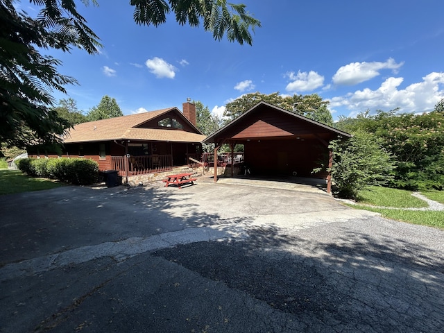 view of front of house featuring covered porch and a carport