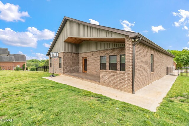 rear view of property with a patio area and brick siding