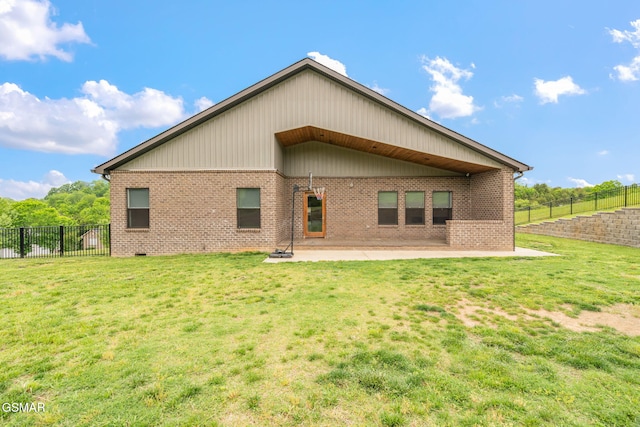 rear view of house with a patio area and brick siding