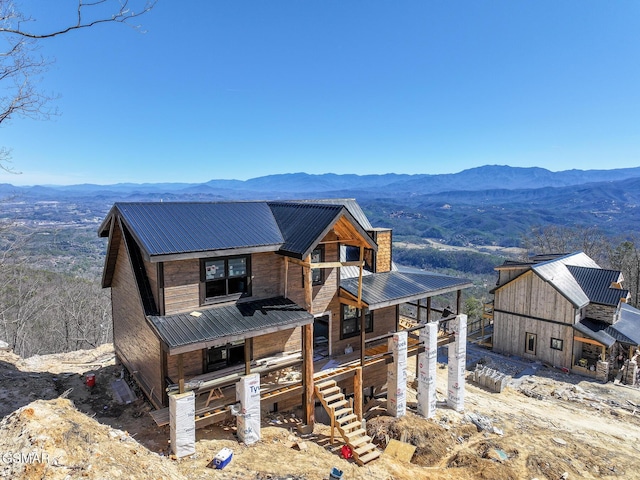 view of front of house featuring a mountain view and metal roof