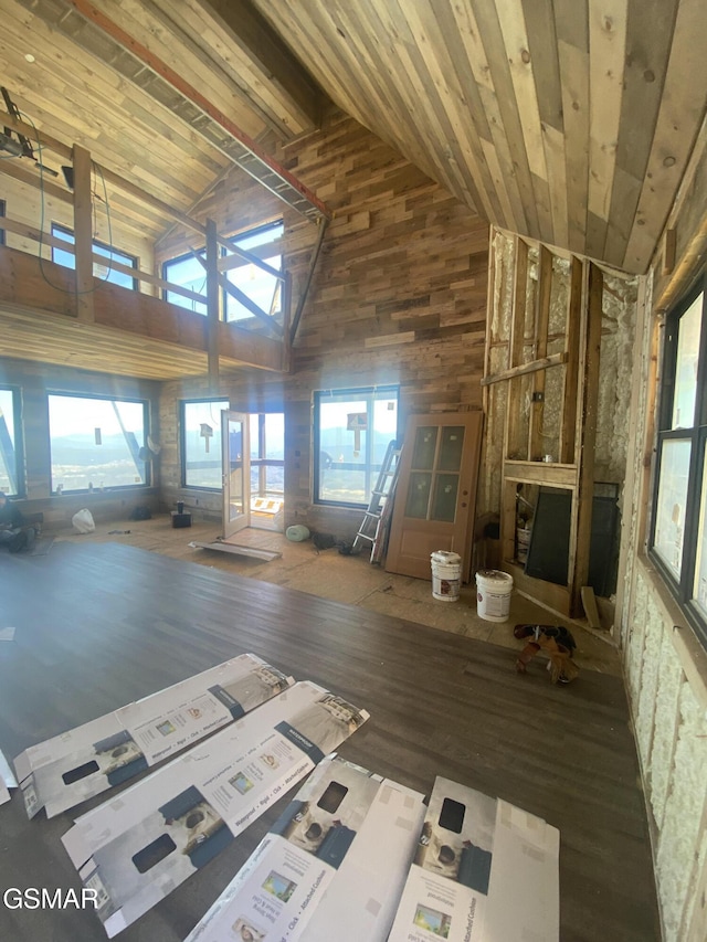 unfurnished living room with high vaulted ceiling, wooden ceiling, and wood finished floors