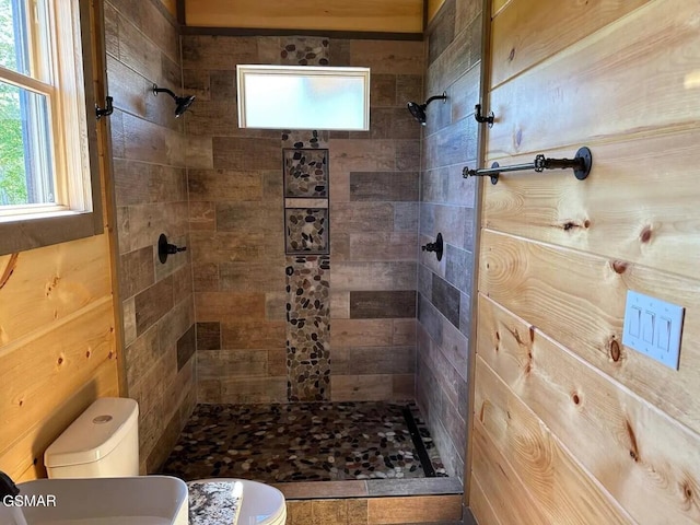 full bathroom featuring a stall shower and toilet