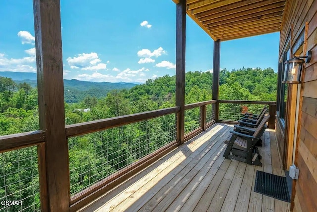 deck featuring a view of trees