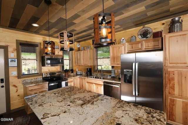 kitchen with a wealth of natural light, light brown cabinets, appliances with stainless steel finishes, and a sink