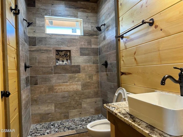 bathroom with vanity, a shower stall, and toilet