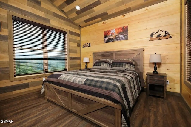 bedroom with lofted ceiling, wood walls, and wood finished floors