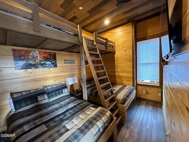 bedroom with wood finished floors, wood ceiling, and wooden walls