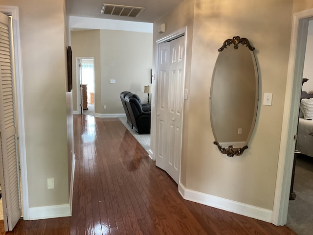 hallway with dark hardwood / wood-style floors