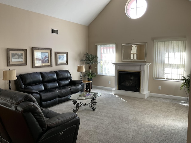 living room with light carpet and high vaulted ceiling