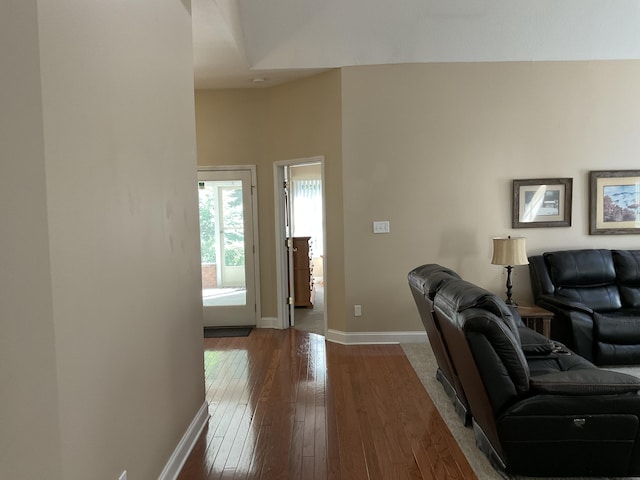 living room featuring wood-type flooring and a high ceiling