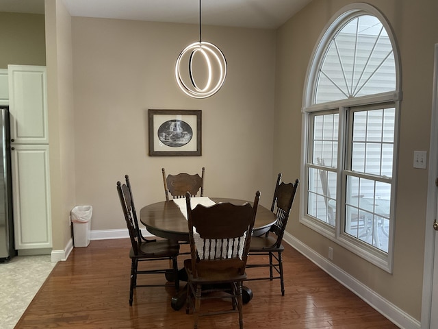 dining space with plenty of natural light and wood-type flooring