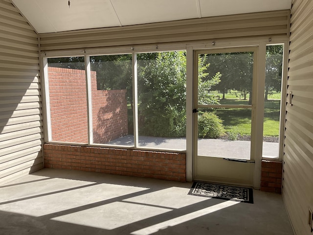 unfurnished sunroom with lofted ceiling