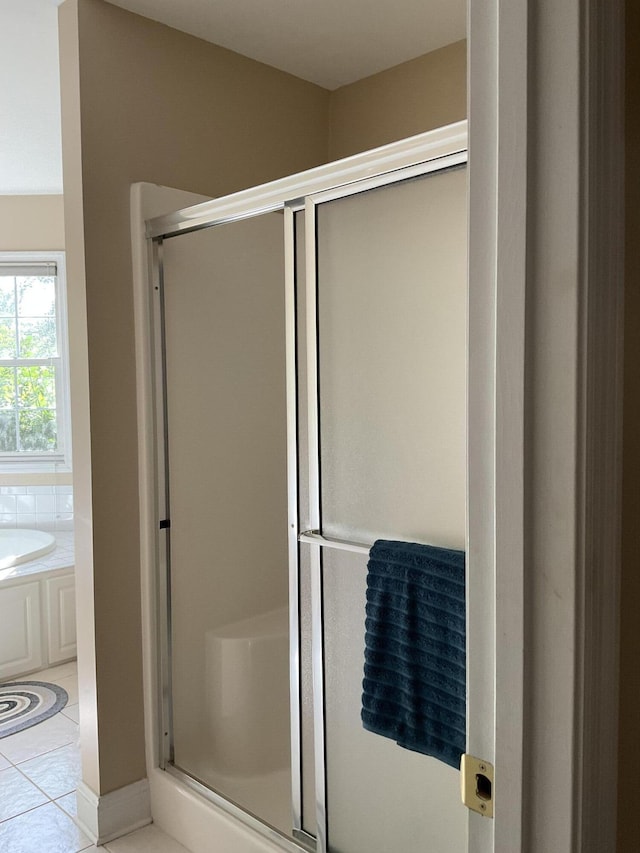 bathroom featuring tile patterned flooring and plus walk in shower