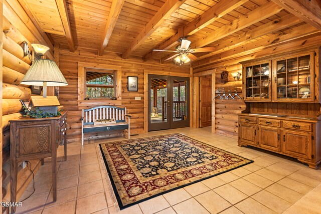 interior space with beamed ceiling, wood ceiling, french doors, light tile patterned flooring, and a ceiling fan