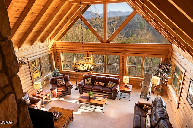 living area featuring a chandelier, plenty of natural light, a mountain view, and high vaulted ceiling