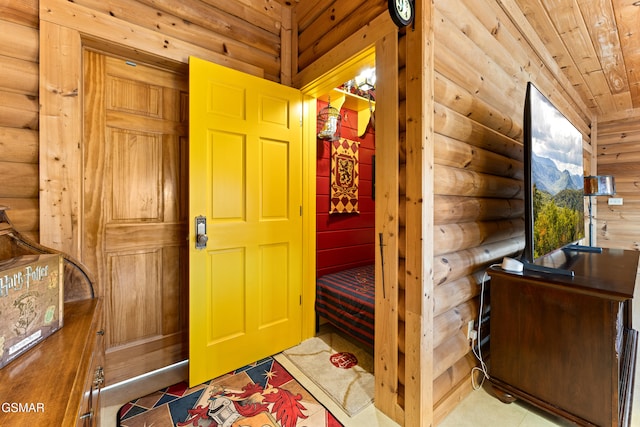 bedroom featuring log walls and wooden ceiling