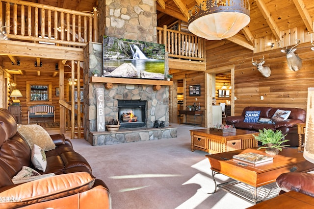 carpeted living area with beamed ceiling, wood walls, wooden ceiling, a fireplace, and a high ceiling