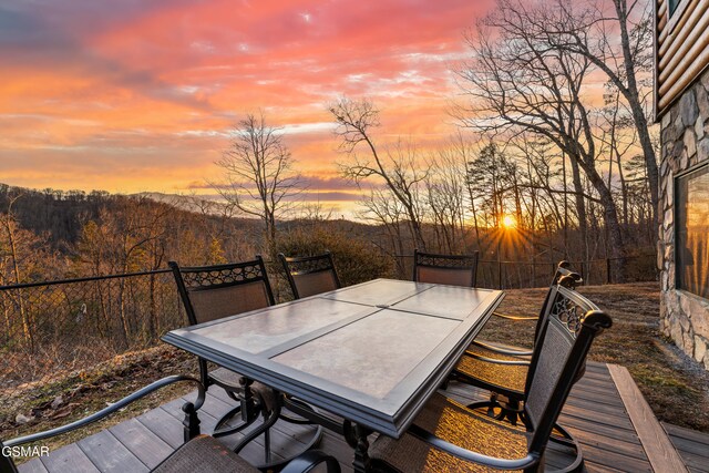 wooden terrace with outdoor dining area