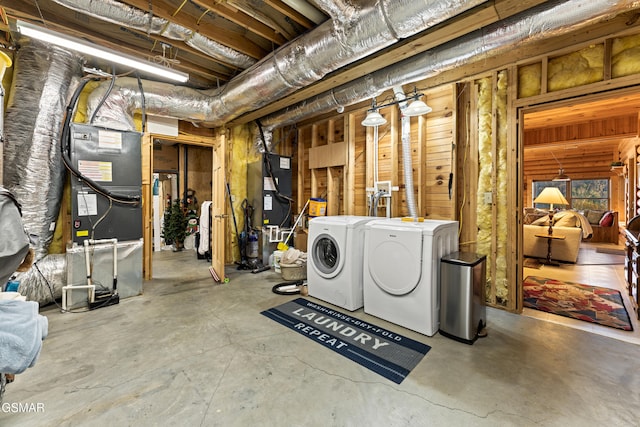 unfinished basement featuring heating unit and separate washer and dryer