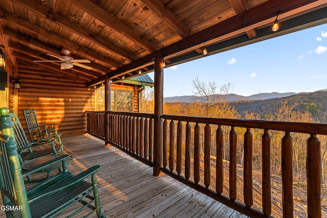 wooden terrace featuring a mountain view and a ceiling fan