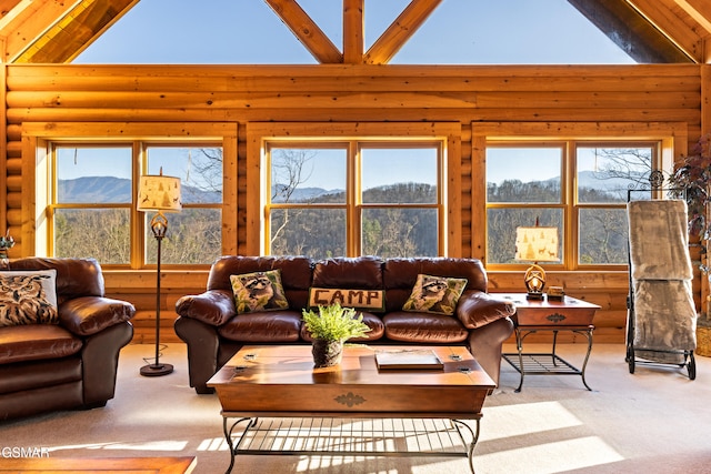 carpeted living room featuring a mountain view, high vaulted ceiling, and log walls