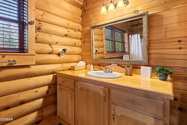 full bath with a healthy amount of sunlight and vanity