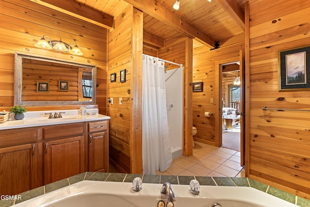 bathroom featuring beamed ceiling, wood walls, a washtub, toilet, and tile patterned floors