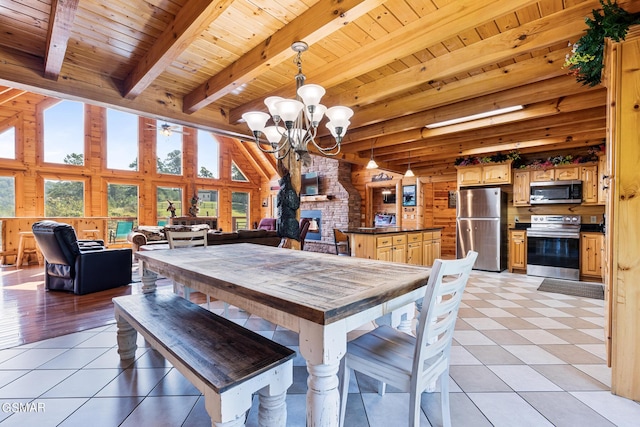 tiled dining area with beam ceiling, an inviting chandelier, and wooden ceiling