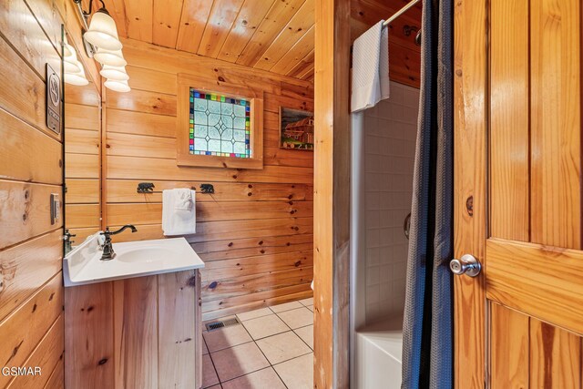 bathroom with tile patterned floors, vanity, wood ceiling, and wooden walls