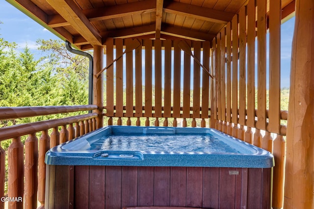 wooden terrace with a hot tub