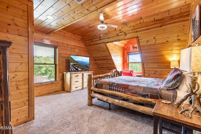 bedroom with light carpet, wood ceiling, vaulted ceiling, ceiling fan, and wooden walls