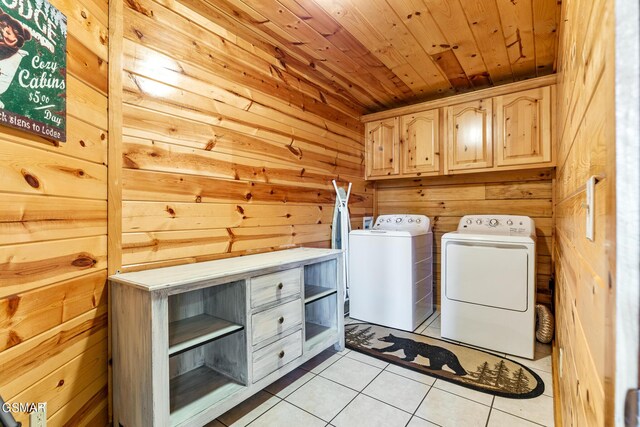 laundry area featuring wood walls, cabinets, light tile patterned floors, and wood ceiling